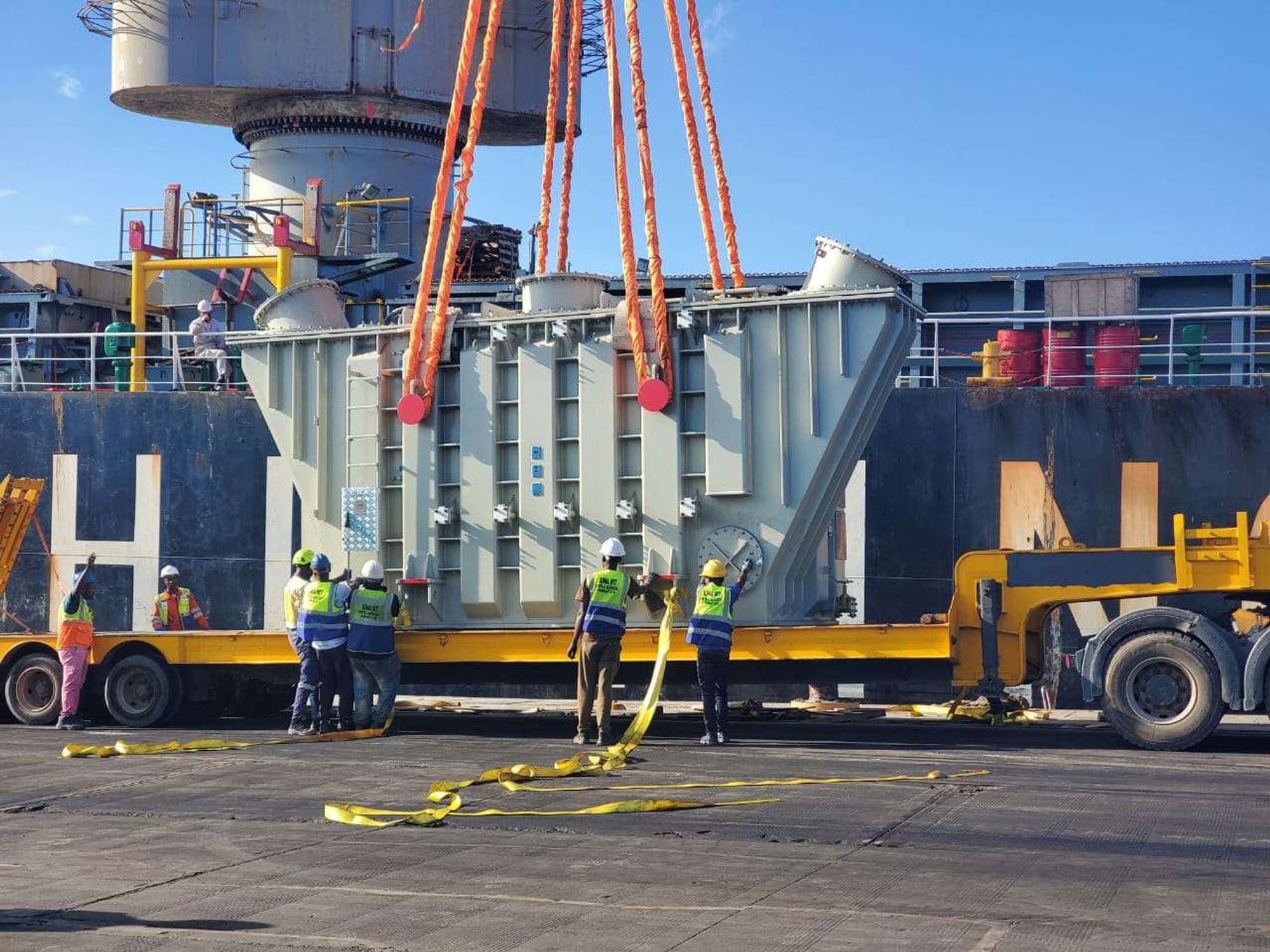 A heavy-lift transformer being loaded onto a vessel during a breakbulk operation