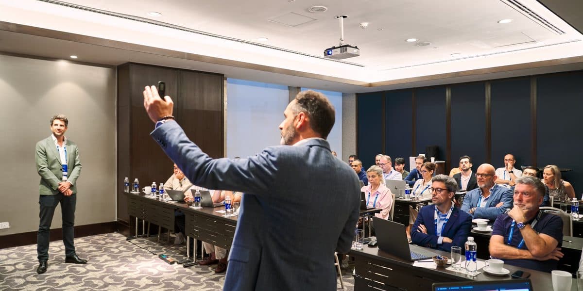 Geert De Wilde presenting to a full room of freight forwarders, with Thijs de Vos, at the AI workshop in Ho Chi Minh City